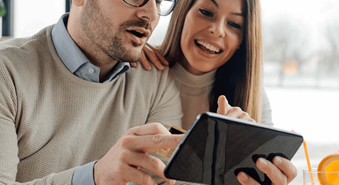 Two people reviewing billing and subscription options on a tablet